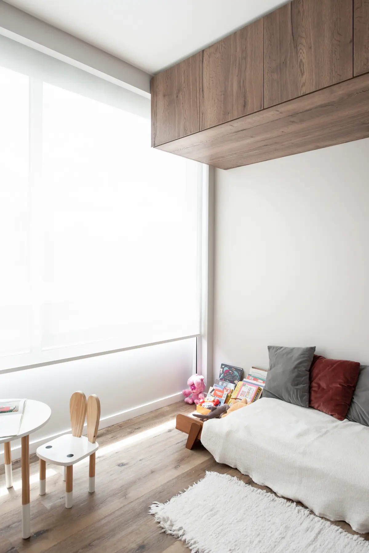 Dormitorio minimalista con silla orejas de conejo y gran ventanal — proyecto Depto Arribeños, por Ayelen Mayer Arquitectura, en Buenos Aires